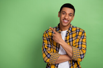 Photo of young youtube blogger perspective influencer direct finger empty space social media contacts isolated on green color background