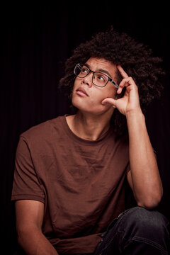 Studio portrait of young colored man with glasses on. Munich, Germany