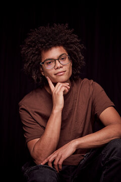 Studio portrait of young colored man with glasses on. Munich, Germany