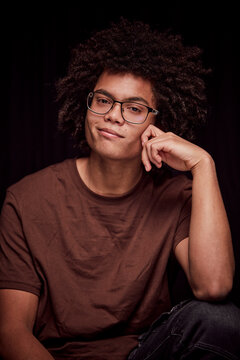 Studio portrait of young colored man with glasses on. Munich, Germany