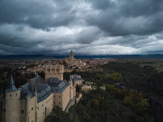 Fototapeta na wymiar The Alcazar of Segovia a medieval castle with cloud sky and forest