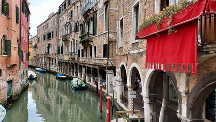 Venice, vertical image of a gondola in a narrow canal