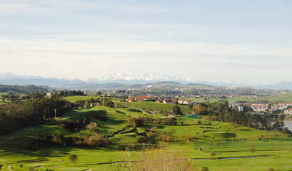 Fototapeta na wymiar Cantabria, view inland over Liencres area, snow on Picos de Europa mountain range