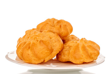 Several delicious eclairs on a white ceramic plate, macro, isolated on white background.