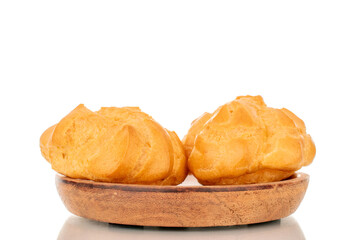 Two delicious eclairs on a wooden plate, macro, isolated on white background.
