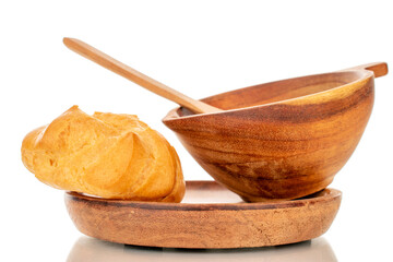One delicious batter on a wooden plate with a wooden cup, macro, isolated on white background.