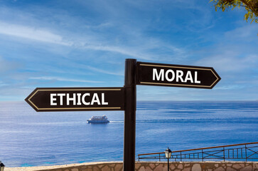 Ethical or moral symbol. Concept word Ethical or Moral on beautiful signpost with two arrows....