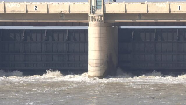 Indus River Head Taunsa Barrage Hydro Electric Gate. Under which the water is flowing very fast.  View of water rushing through the gates at a dam. Beautiful 4K Footage.