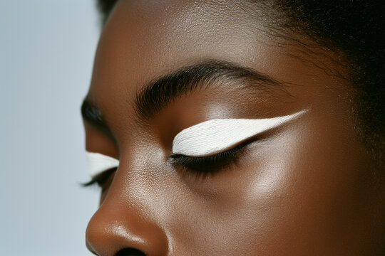 Artistic close-up of a woman's eyes featuring bold white eyeliner on a smooth skin. Generative AI image