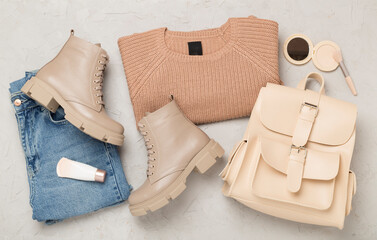 Flat lay with trendy spring outfit on concrete background, top view