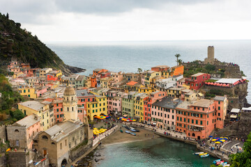 View of the colorful town of Vernazza under a cloudy sky, Cinque Terre, Liguria,  Italy