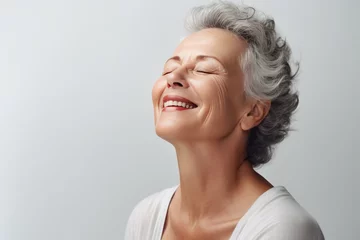 Fotobehang Gorgeous senior older woman with closed eyes touching. Beautiful portrait mid 50s aged woman advertising facial antiage lift products salon care tighten skin © Nico