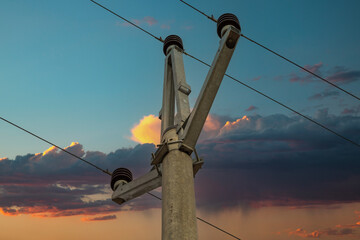 Electric high voltage pole. In the background is a dramatic sky.