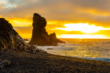 Sunset over the volcanic lava formations of Djupalonssandur beach,  Iceland