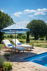 Two chaise lounges sit by the edge of a pool overlooking a scenic landscape