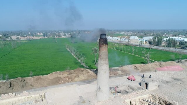 In the area of layyah, a brick kiln has been built inside the village without following any regulations, which is a serious risk to the environment. Environmental problem pollution.  Dron 4K Footage.