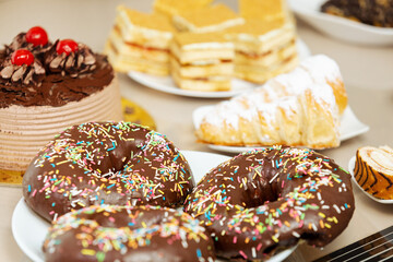 Lots of sweets on a table, variation of pastry products and donuts with chocolate, sugar addiction....