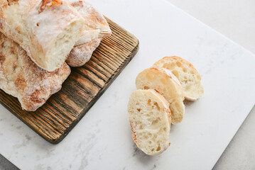 Rustic French sourdough baguettes on wooden cutting board