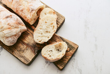 Rustic French sourdough baguettes on wooden cutting board