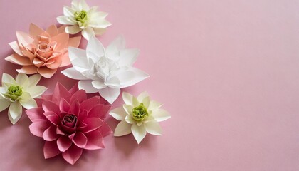 Fototapeta na wymiar origami paper flowers on pink background with copy space minimal concept