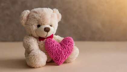 small teddy bear with a pink heart on a beige background side view selective focus copy space valentine s day