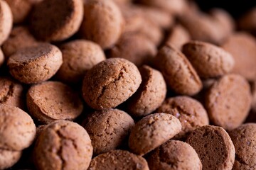 A macro portrait of a delicious dutch treat called pepernoten. Pepper nuts are a traditional cookie during holidays and saint nicholas or sinterklaas in dutch and it tastes like gingerbread.