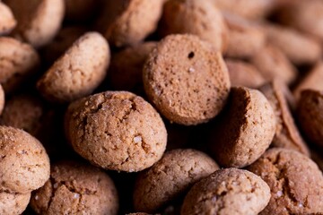 A tasty closeup portrait of a lot of delicious traditional dutch snacks called pepernoten or...