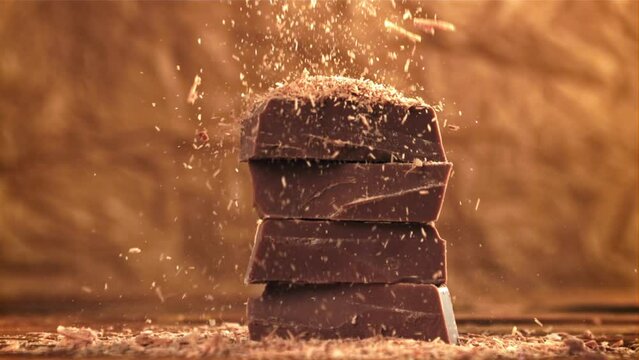 The grated chocolate falls on the chocolate slices. Filmed on a high-speed camera at 1000 fps. High quality FullHD footage