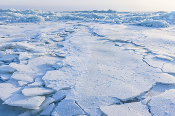 Ice hummocks covered with snow. Landscape with coast of frozen sea © evannovostro