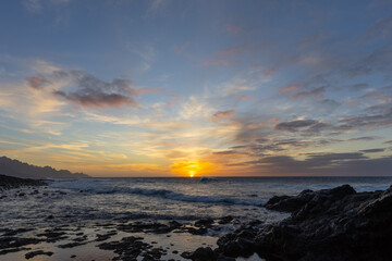 Sunset by the ocean and natural bathing pools of Agaete, Gran Canaria, Spain