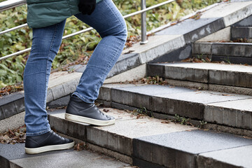 woman climbing the stone steps of the stairs.