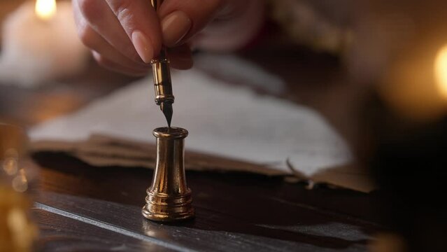 Antique female writing with old feather pen. Woman in renaissance dress writing a love letter with vintage quill pen on old parchment papers sheet.