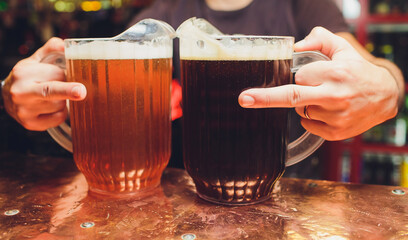 close-up of barman hand at beer tap pouring a draught lager beer.
