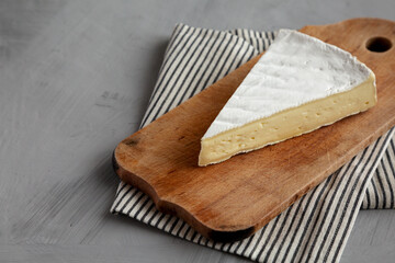 Organic Brie Cheese on a wooden board, low angle view. Copy space.