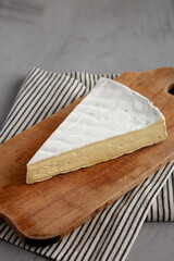 Organic Brie Cheese on a wooden board, low angle view.