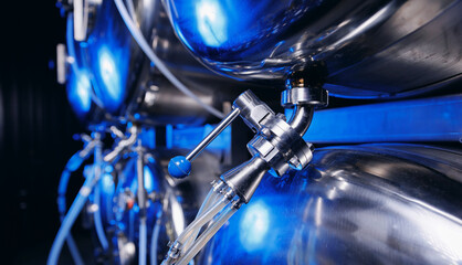 Industrial valve on factory beer drink and food equipment pipe stainless tubes with blue light