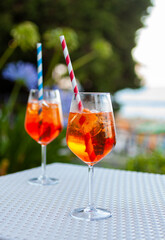 Two aperol spritz on a summer evening in a mediterranean pub - 737527539