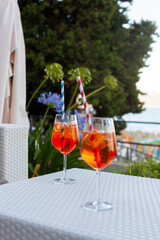 Two aperol spritz on a summer evening in a mediterranean pub - 737527589