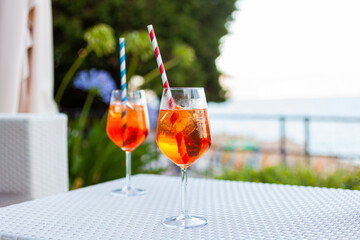 Two aperol spritz on a summer evening in a mediterranean pub - 737527718