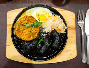 Blood sausage with barley salad and egg served on platter