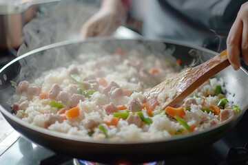 A frying pan filled with a delicious combination of rice and vegetables. Perfect for a healthy and nutritious meal. Suitable for recipe websites, cooking blogs, and food-related articles