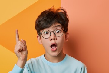 Excited Asian boy amazed and pointing showing interest