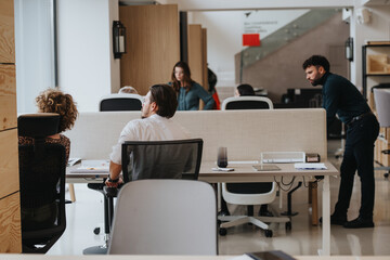 A modern office environment with a diverse group of professionals focused on their tasks. The...