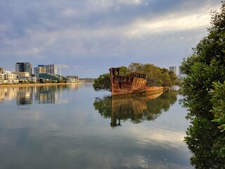 Obraz premium The Abandoned SS Ayrfield (historic ship) in Wentworth Point Harbor at Sunrise - Sydney, Australia