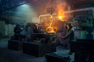 Workers pour molten metal at steel foundry. Industrial team in protective gear casting, manufacturing in heavy industry. Hot metal forging, teamwork, metallurgy. Workshop, furnace operation.