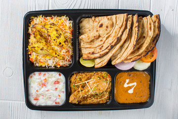 Indian Hindu Veg Thali/food platter consists variety of veggies, lentils, sweet dishes, snacks