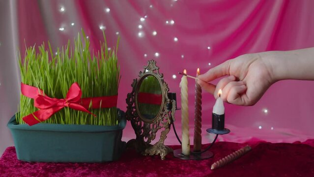Hand lighting candles for Novruz celebration