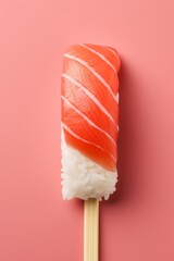 Close-up of fresh sushi with chopsticks in minimalistic style on pastel pink background, vertically - obrazy, fototapety, plakaty