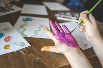 Children's drawing workshop, happy children make handprints with paint