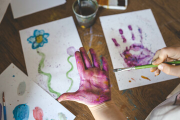 Children's drawing workshop, happy children make handprints with paint